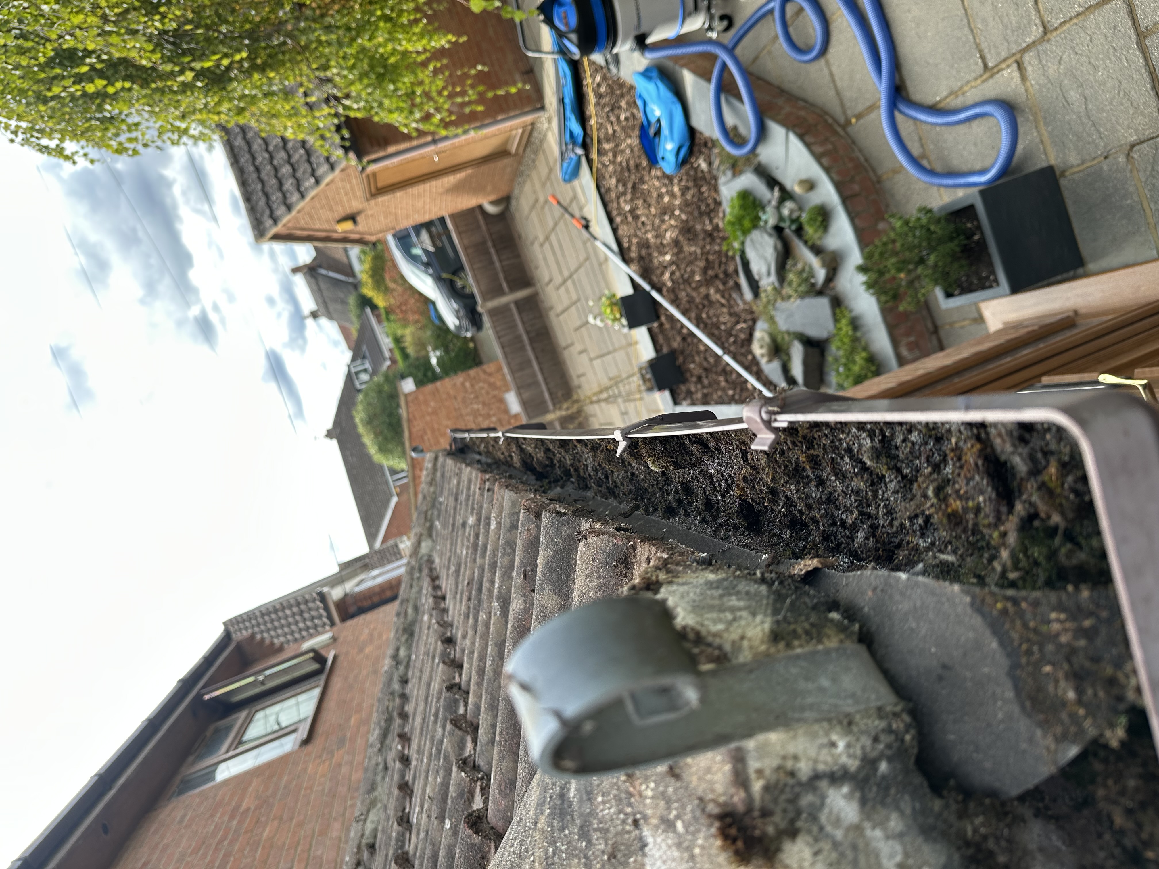 Gutter cleaning on a UK house roofline